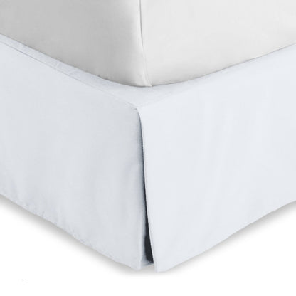 Bed skirt on a bed with white bedding