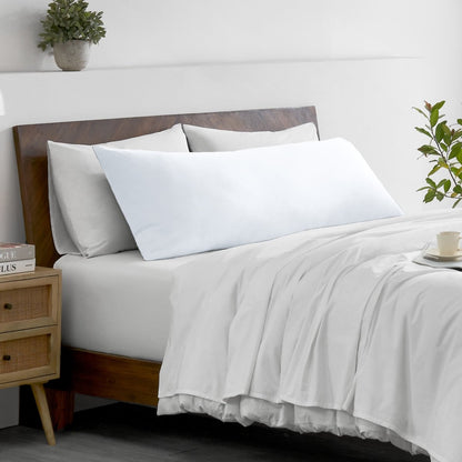 Bed with microfiber bedding and wooden headboard in a bedroom setting
