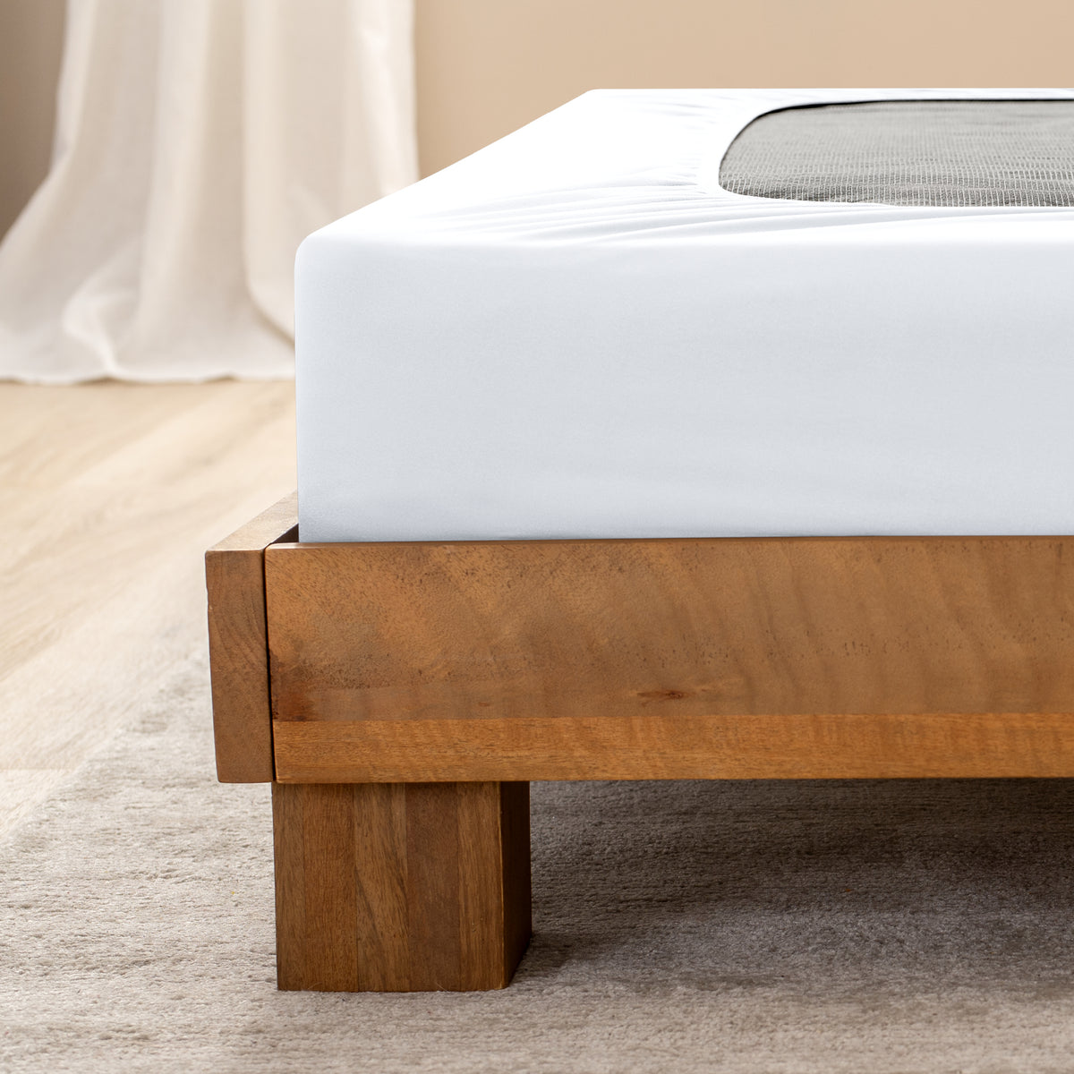 Close up of the corner of a bed frame with a cover box spring 