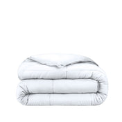 Folded white comforter on a white background