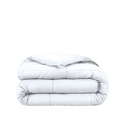 Folded white comforter on a white background