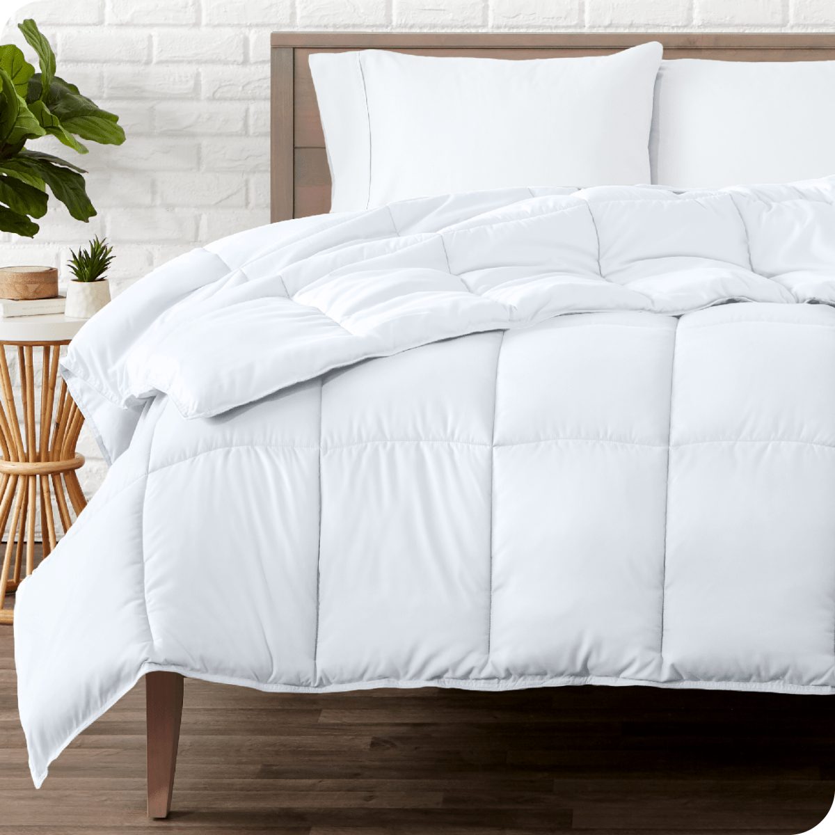 A modern bedroom with a duvet insert on a bed folded back over itself