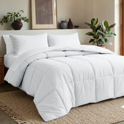 Comforter set on a bed in a bedroom with plants and decor.