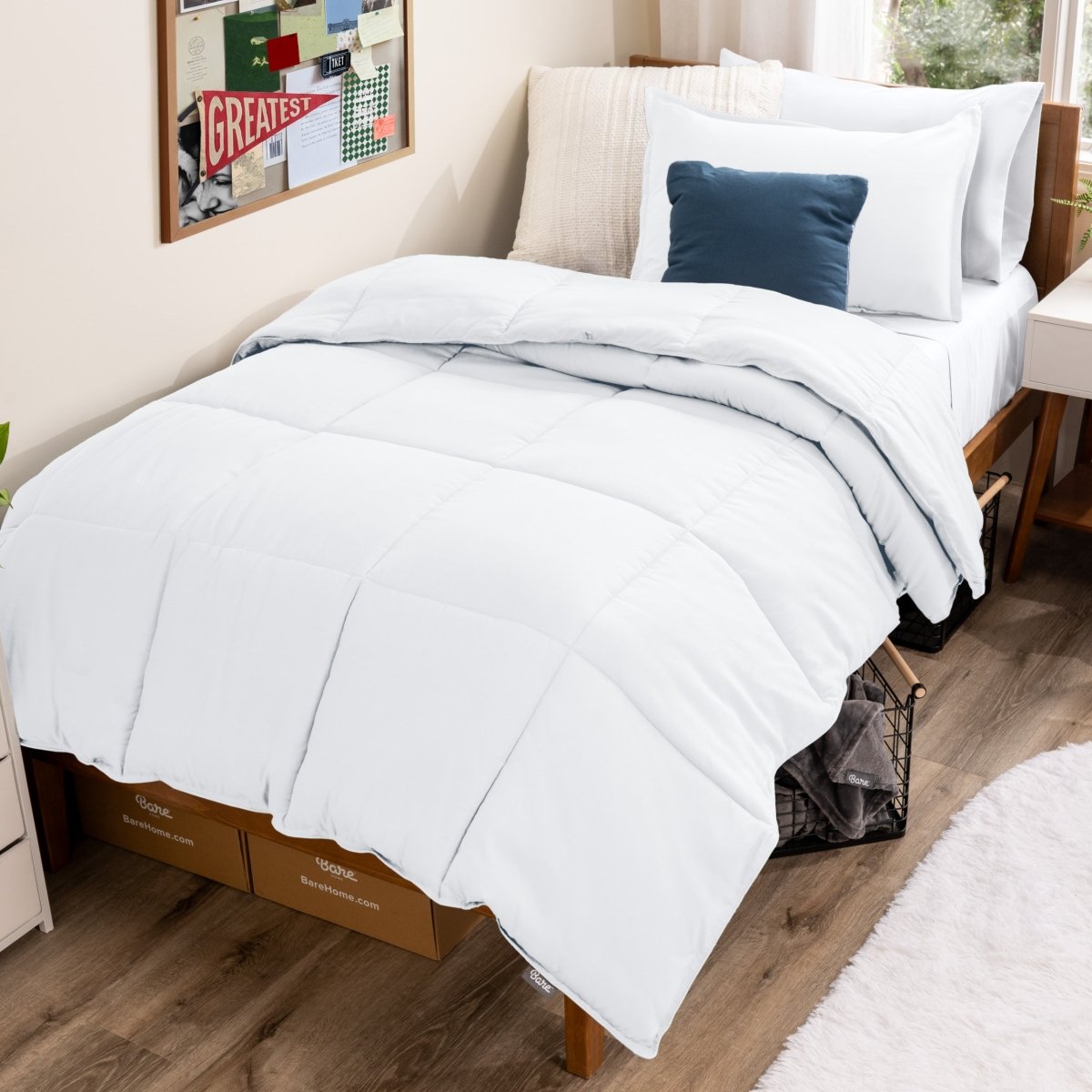 Bed with comforter and pillows in a dorm room