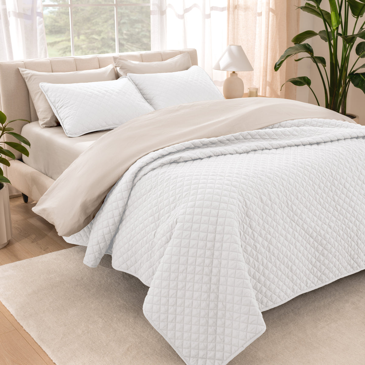 Bedroom showing coverlet set laying on the bed with the quilt folded over on itself