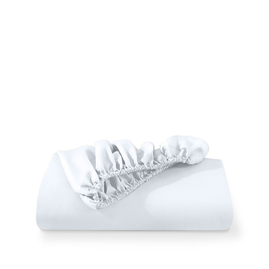 A deep pocket fitted sheet folded on a white background