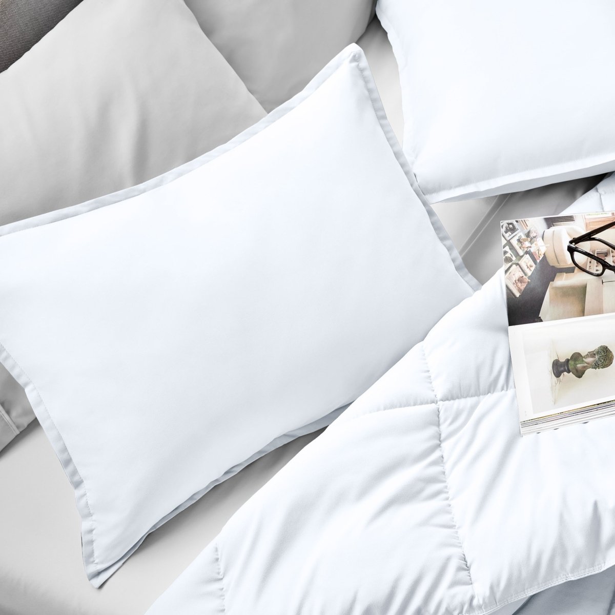 Microfiber pillow sham set on a bed with a magazine on top of the comforter.
