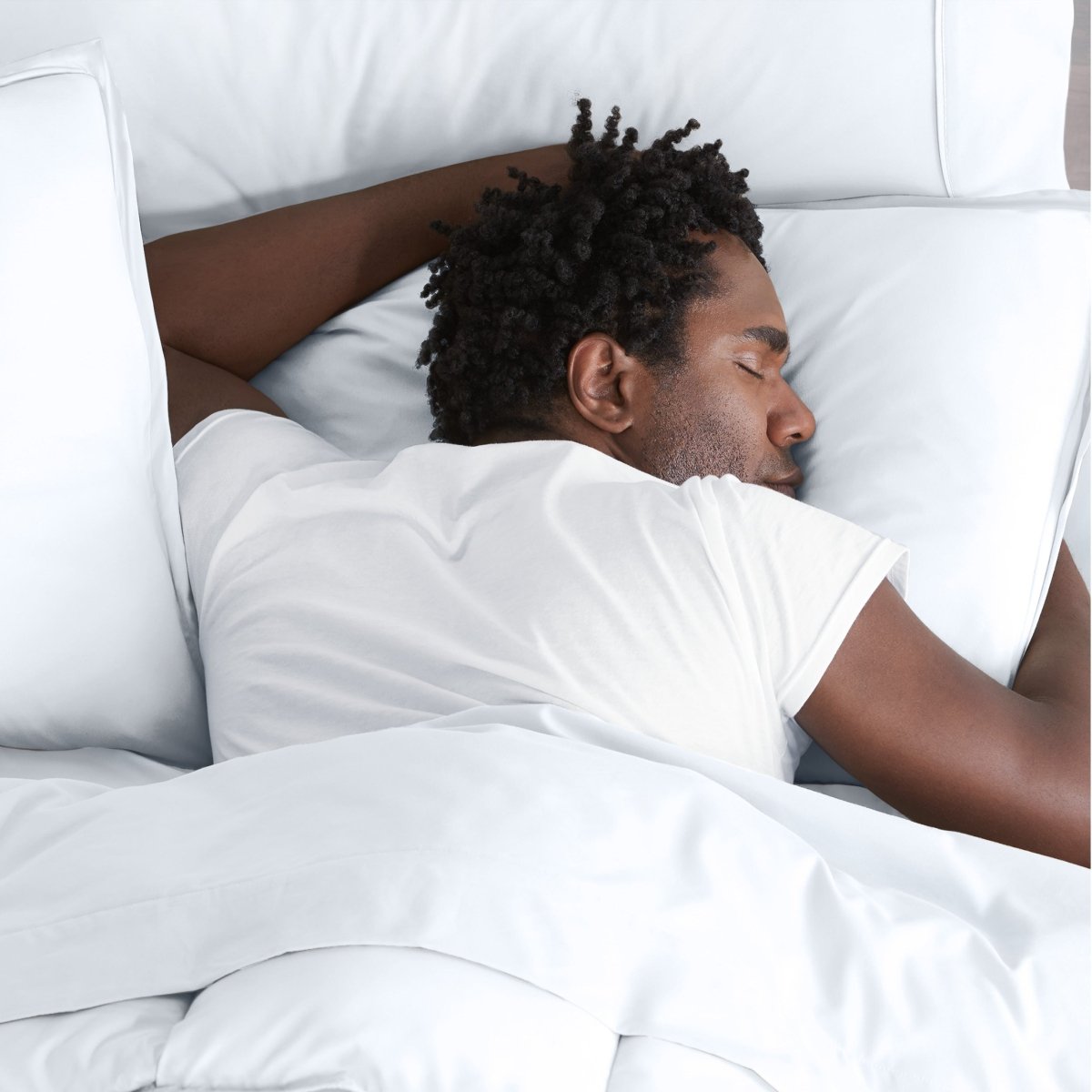 Man sleeping on a bed with microfiber bedding