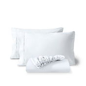 Pillowcases and a matching fitted sheet folded in front, shown on a plain white background.