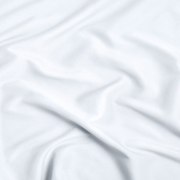 A close-up of ultra soft sheet fabric with soft folds and a smooth texture