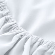 A close-up of a fitted sheet with elasticized edge.