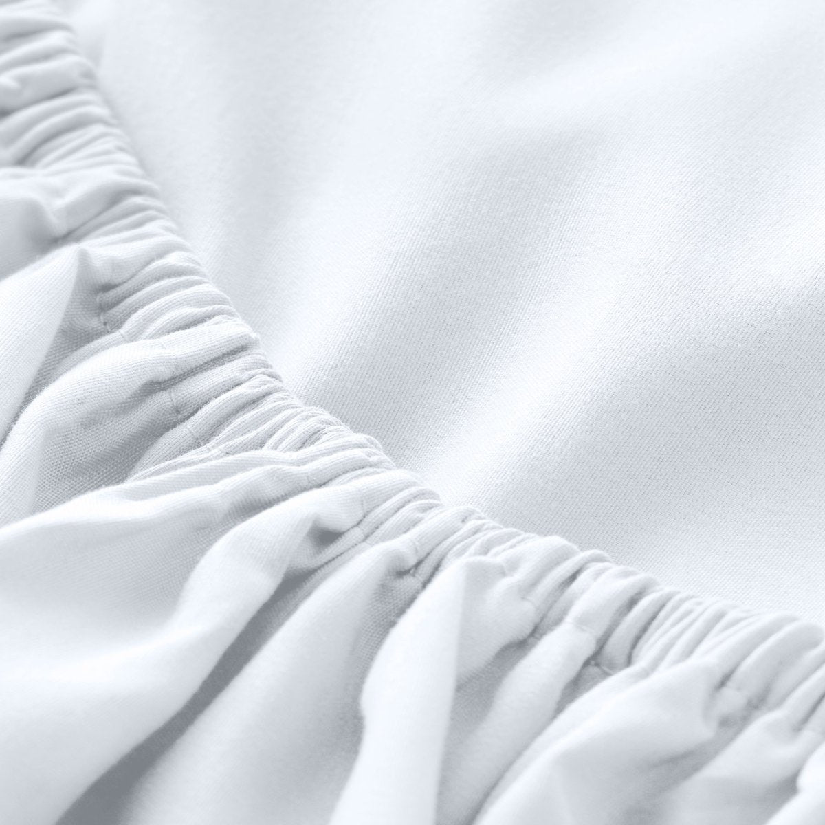 A close-up of a fitted sheet with elasticized edge.