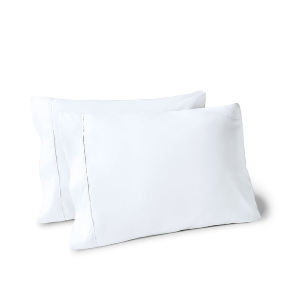 Two pillows on a white background with pillowcases on them