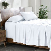 A cozy bedroom featuring a neatly made bed with soft, microfiber sheets.