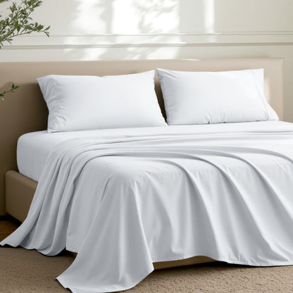 Microfiber sheets on a bed in a well-lit room with a plant.