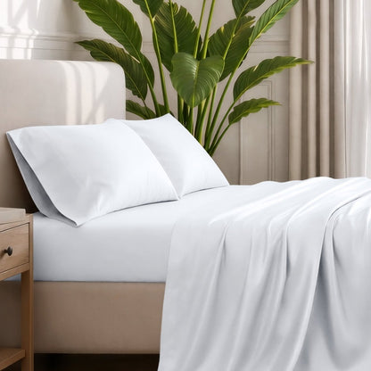 Ultra-soft sheets and pillowcases on a bed with a plant in the background