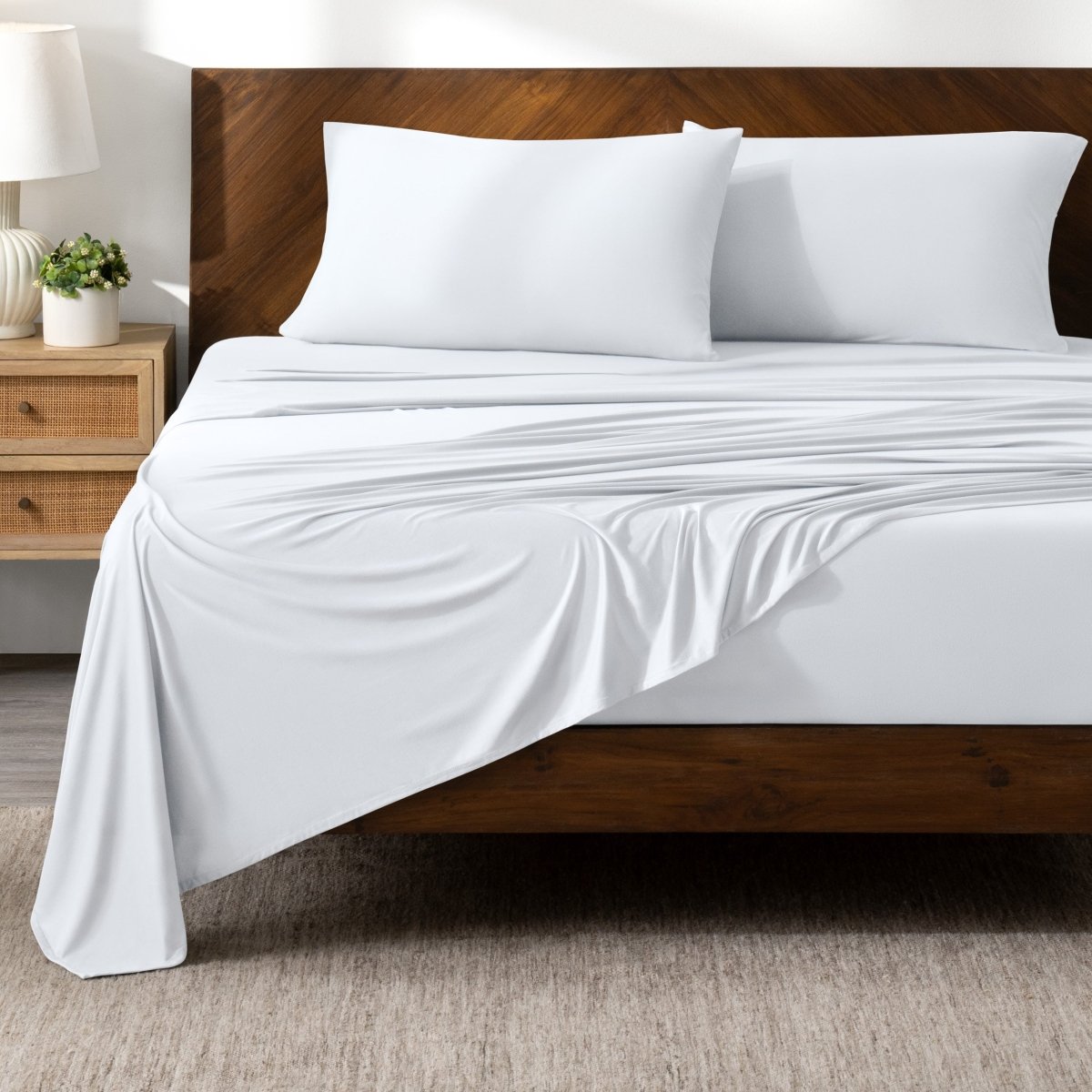 Bed sheets on a wooden bed in a bedroom setting