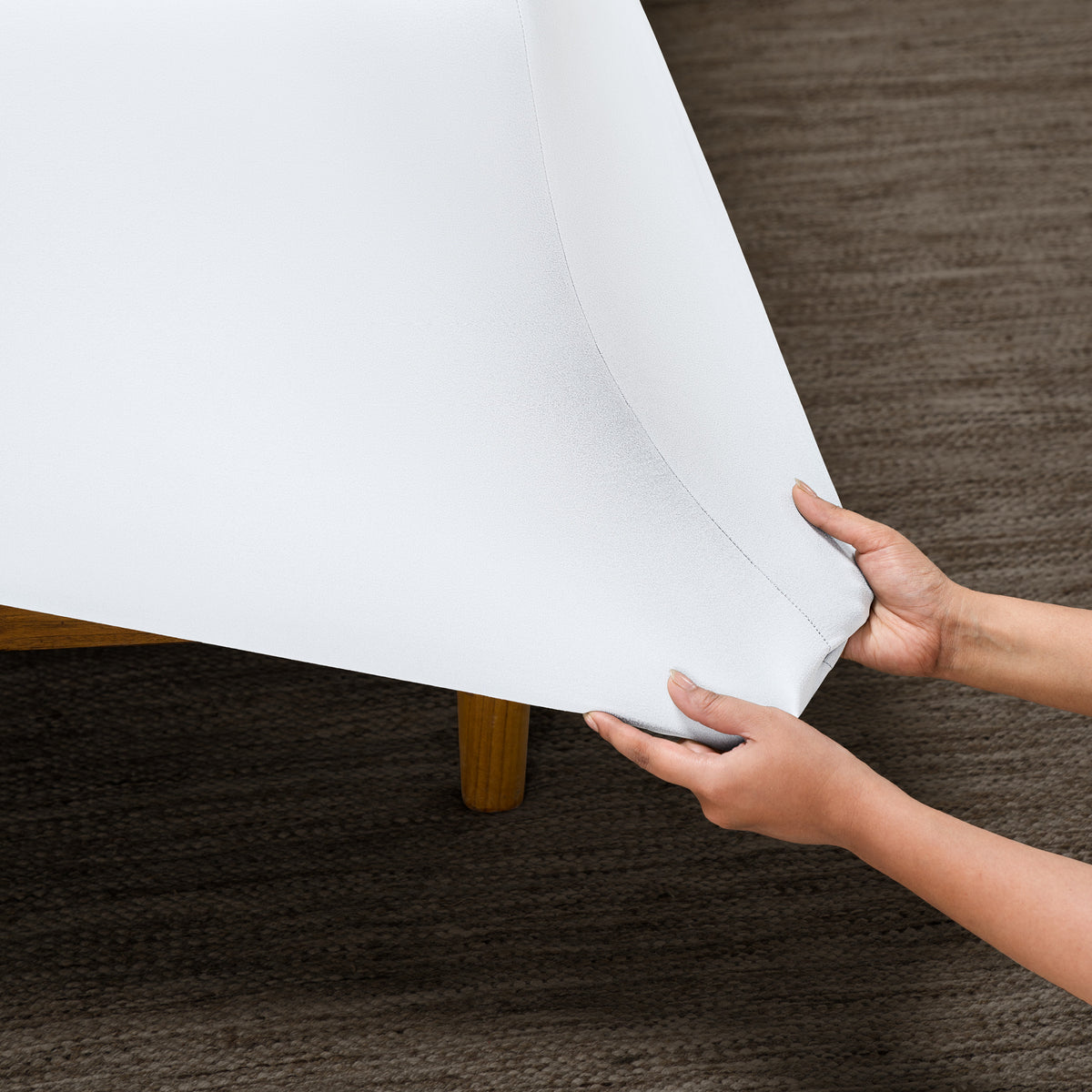 Person putting a microfiber stretch fitted sheet on a mattress