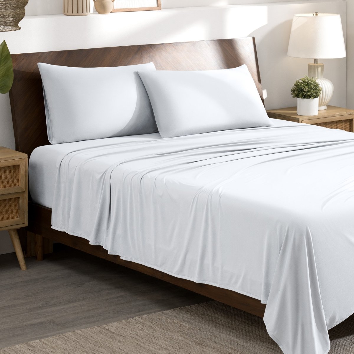 Bed sheets and pillows on a bed in a bedroom setting.
