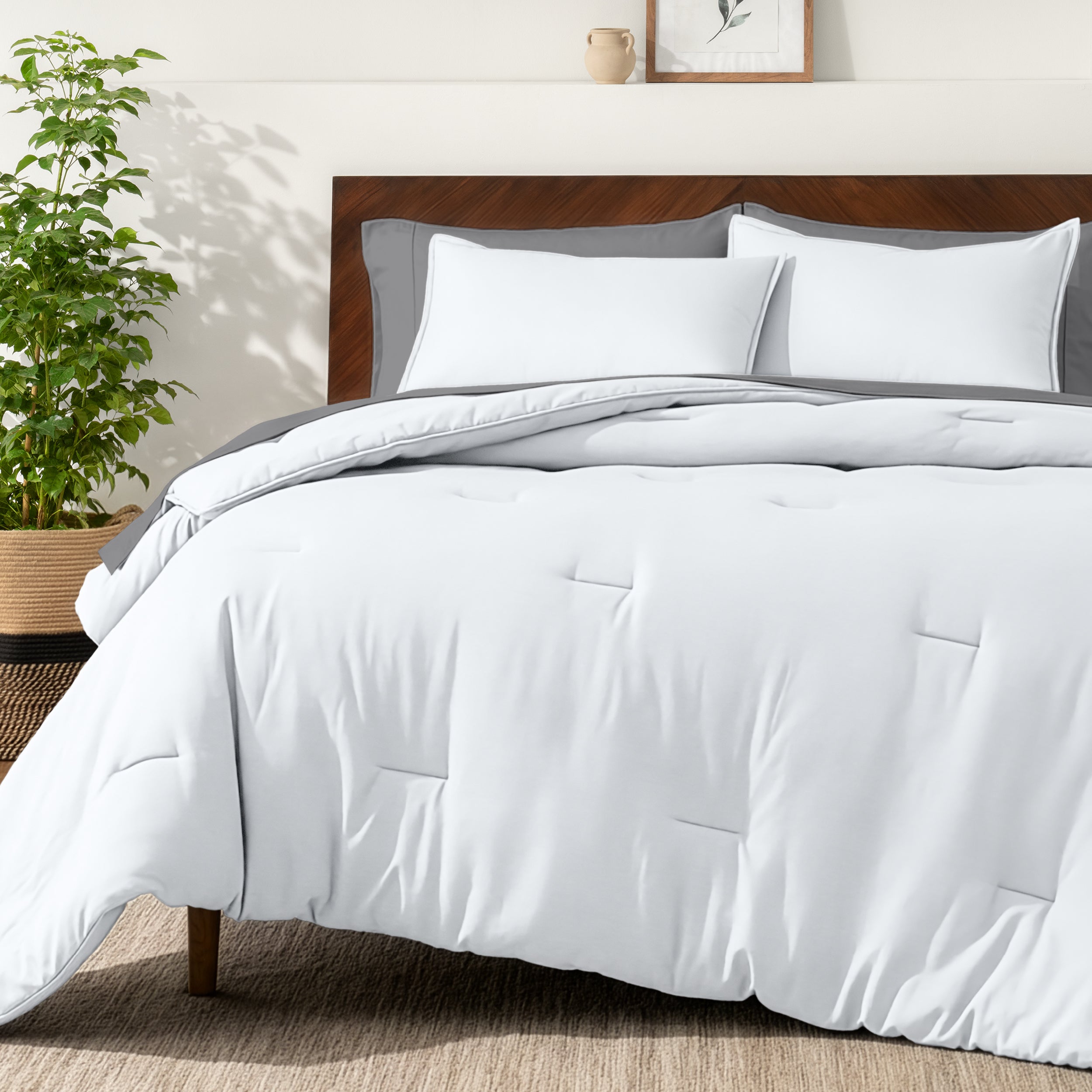 Bedding set on a bed in a bedroom with a side table and lamp.