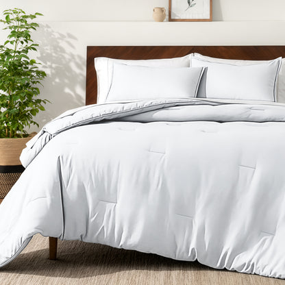 Bedding set on a bed in a bedroom with a side table and lamp.