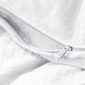 Close-up of a duvet cover with a zipper, featuring the brand Bare Home