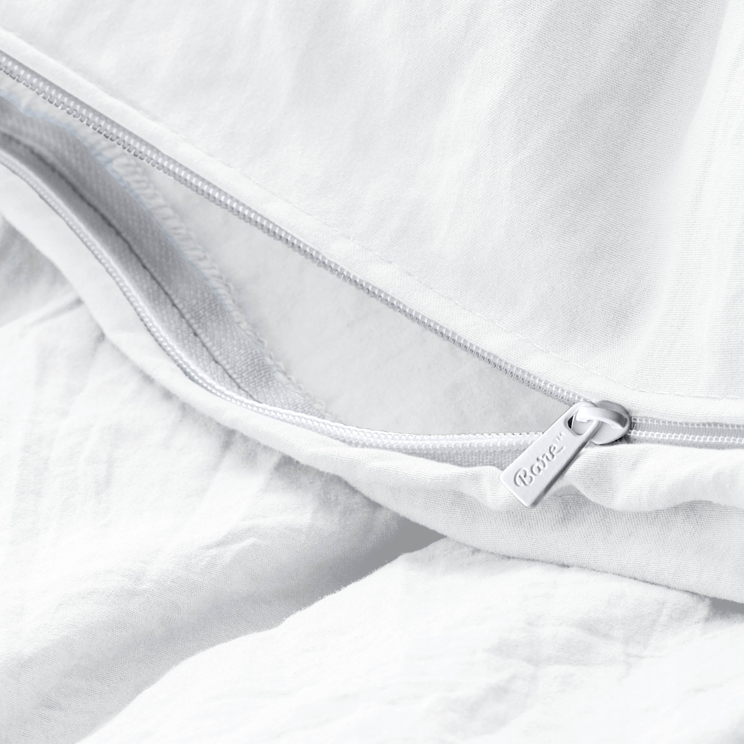 Close-up of a duvet cover with a zipper, featuring the brand Bare Home