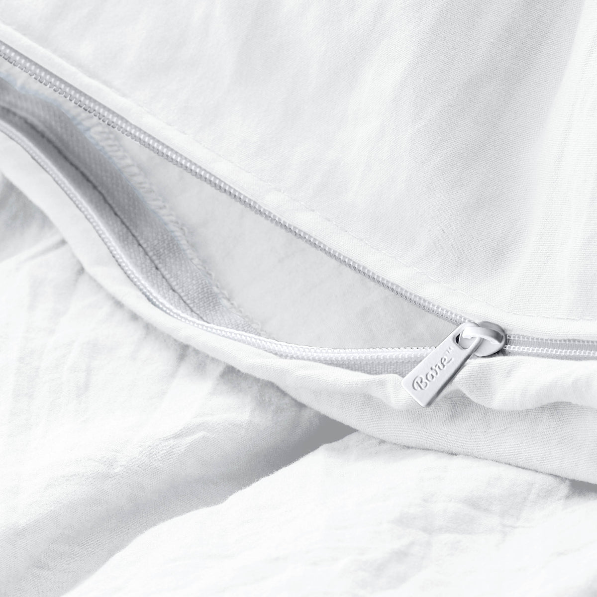 Close-up of a duvet cover with a zipper, featuring the brand Bare Home