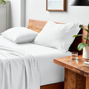 Bed with microfiber bedding and pillows in a bedroom setting