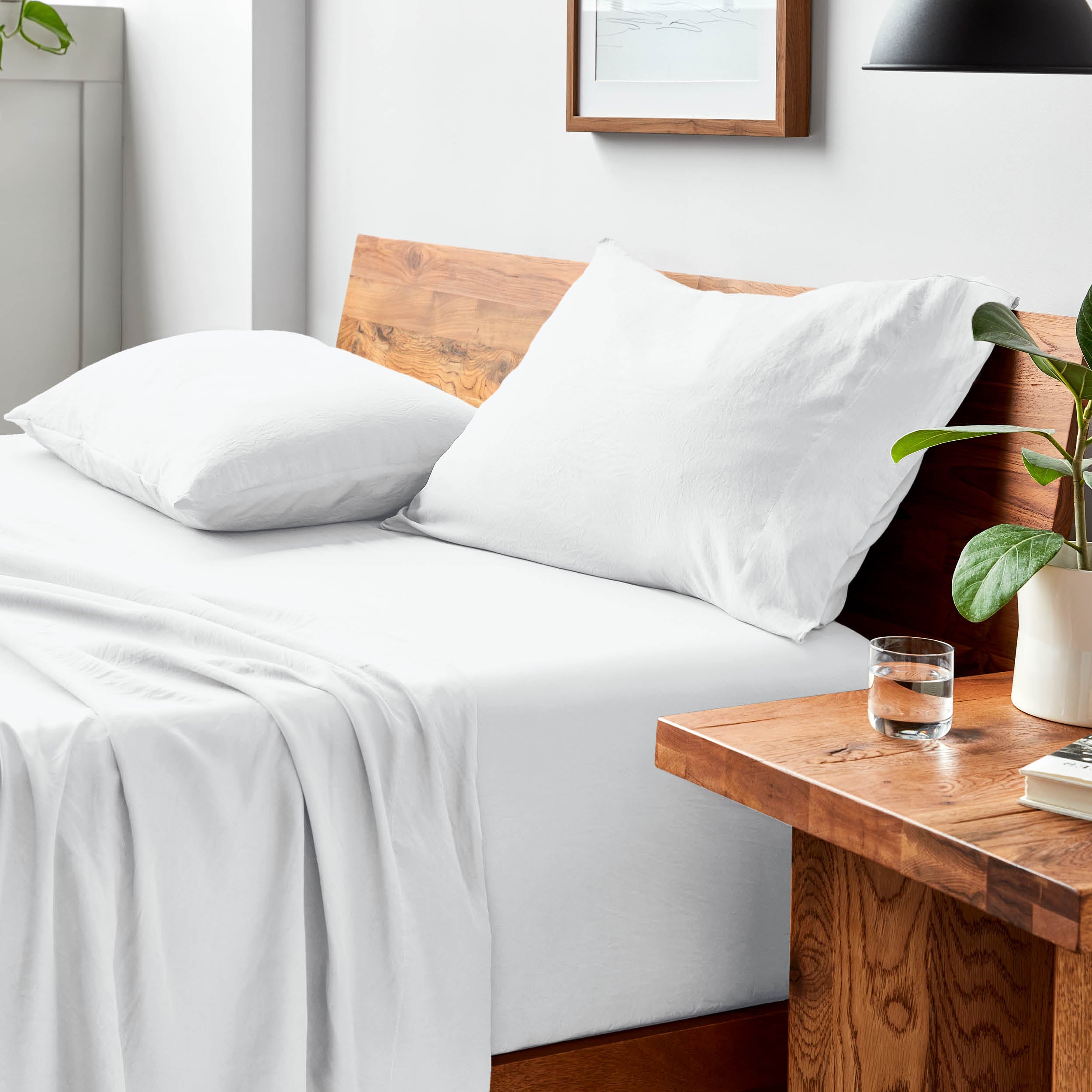 Bed with microfiber bedding and pillows in a bedroom setting