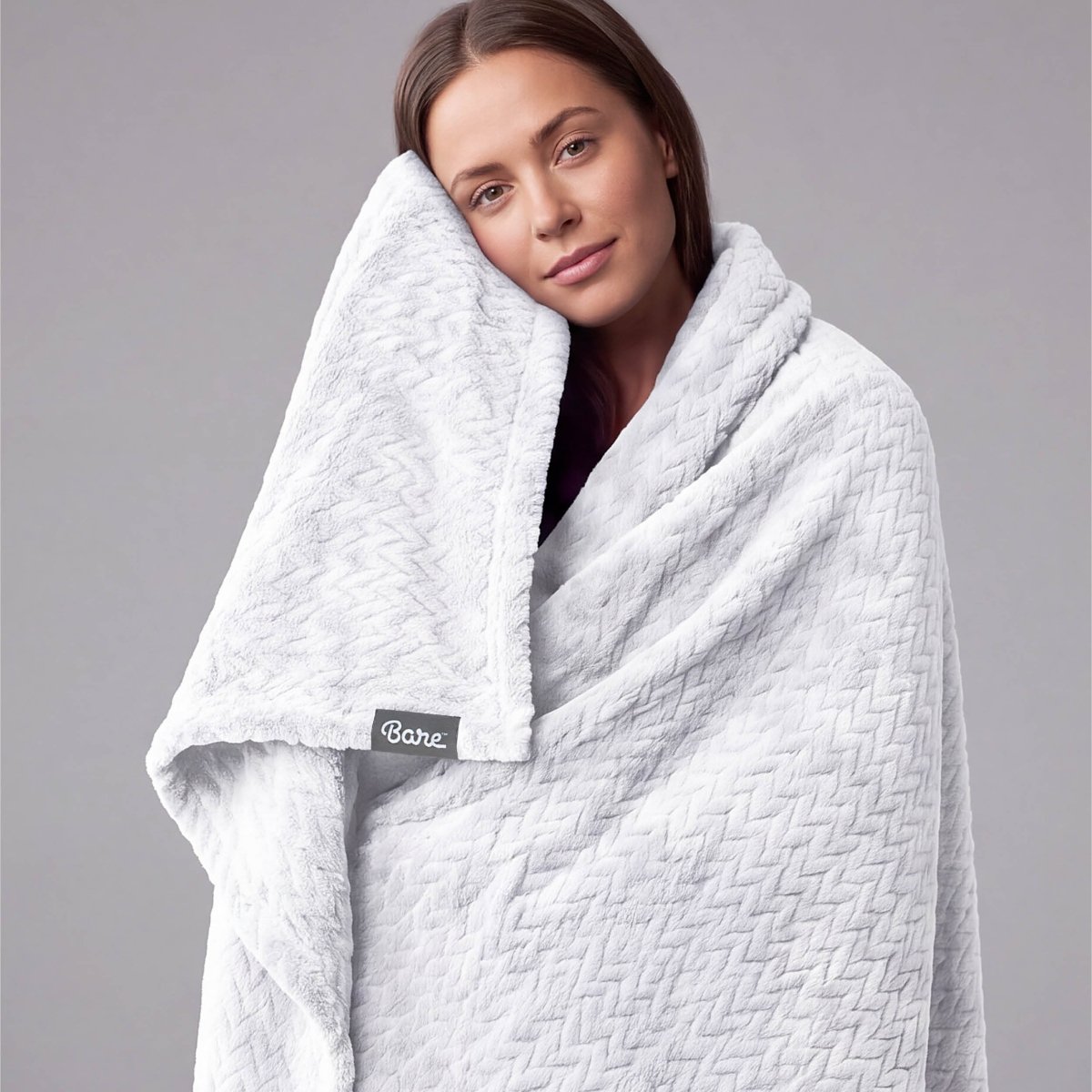 A woman wrapped in a chevron microplush blanket