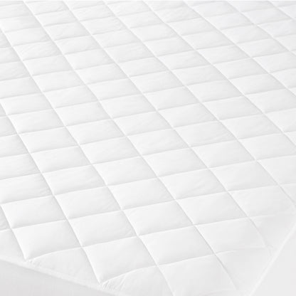 Close-up of a quilted mattress cover with a diamond pattern.