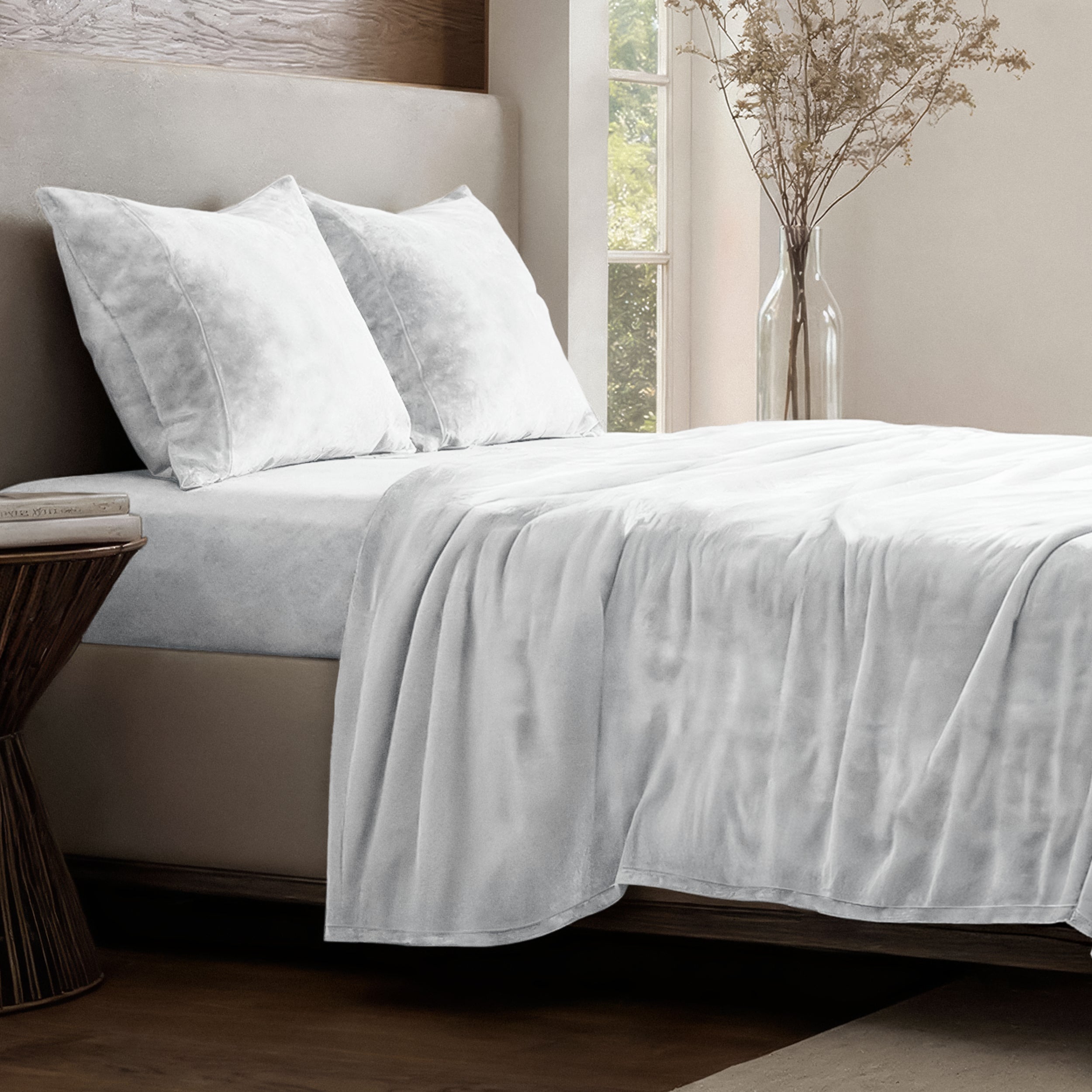 Neatly made bed in a well-lit bedroom.