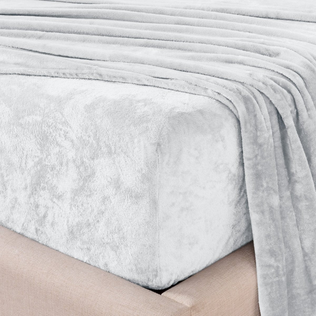 Close-up of the corner of a bed made with microplush sheets