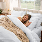 Woman sleeping on a bed made with percale sheets and duvet cover