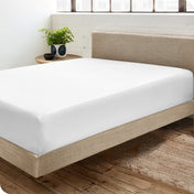 Diagonal view of modern bedroom with a sateen fitted sheet on the bed