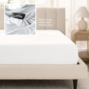 Sateen fitted sheet on a bed with a close-up of a sewn-in tag, set in a bedroom.