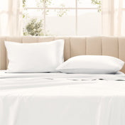 Pillows on a bed with in a bright room.