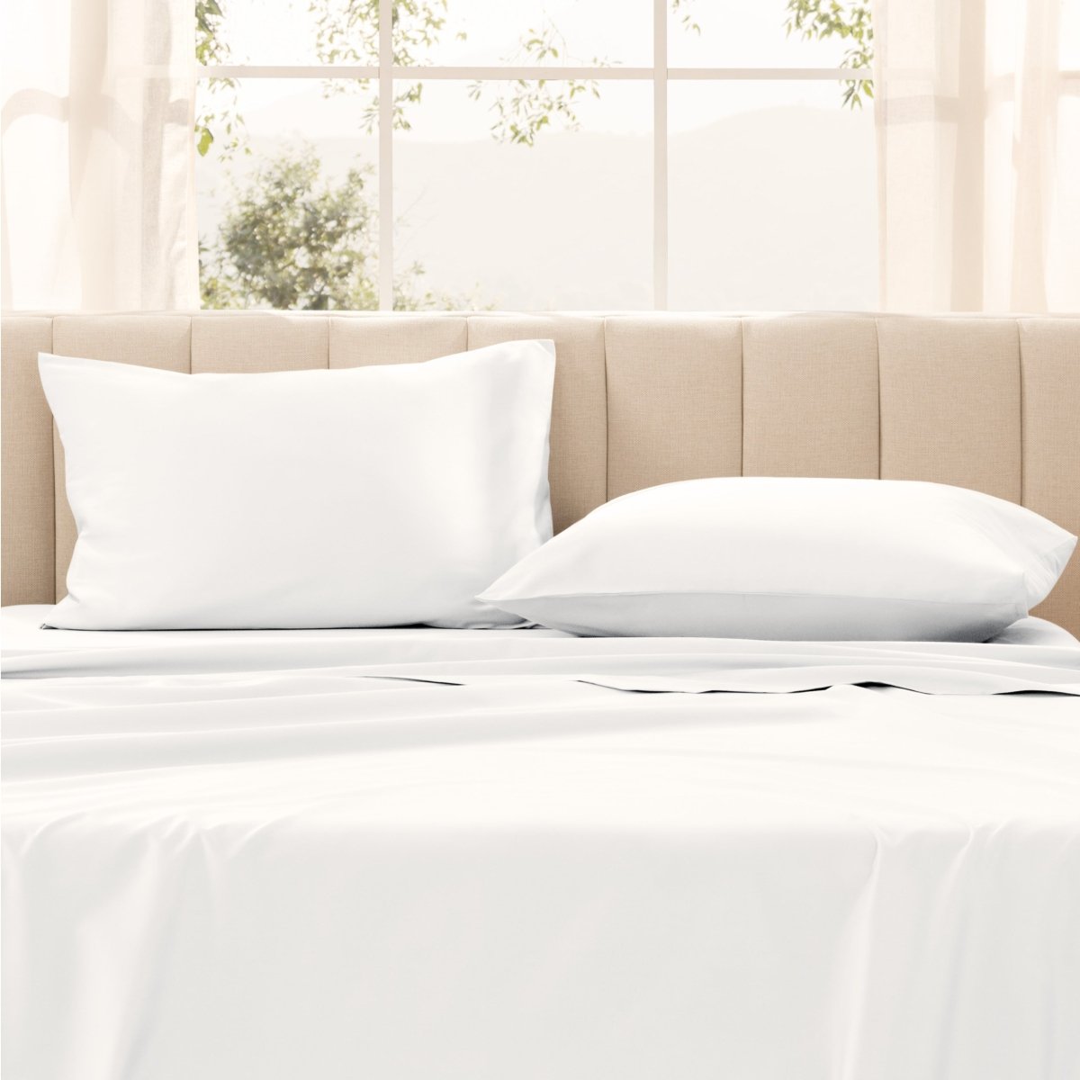 Pillows on a bed with in a bright room.