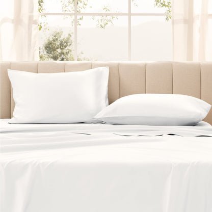 Pillows on a bed with in a bright room.