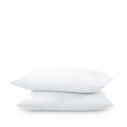 Two pillows stacked on a white background