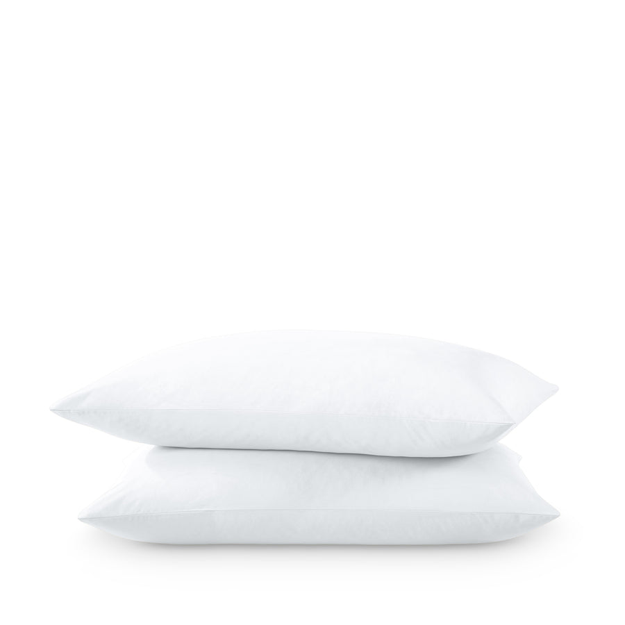 Two pillows stacked on a white background