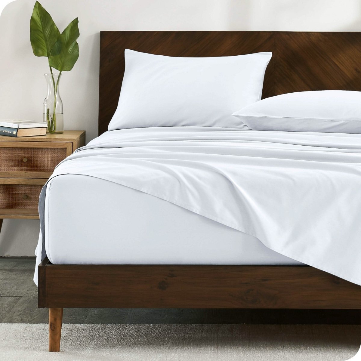 A bed made with organic cotton sateen sheets