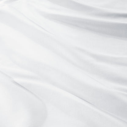 A close-up of draped sateen fabric with soft folds and a smooth texture.