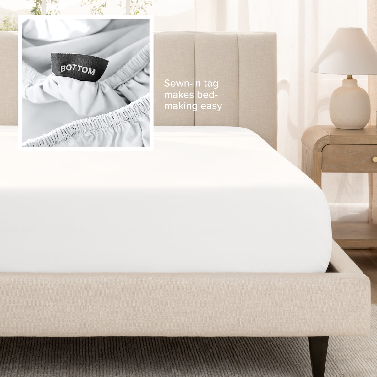 A fitted bed sheet shown on a bed. Text on the image says the sewn-in tag makes bed-making easy.