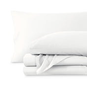 A sateen sheet set folded and stacked on a white background.