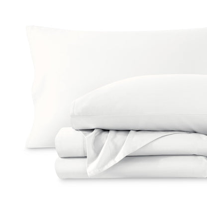 A sateen sheet set folded and stacked on a white background.