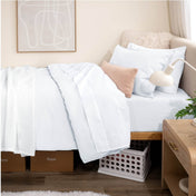 Bed with percale bedding in a dorm room setting