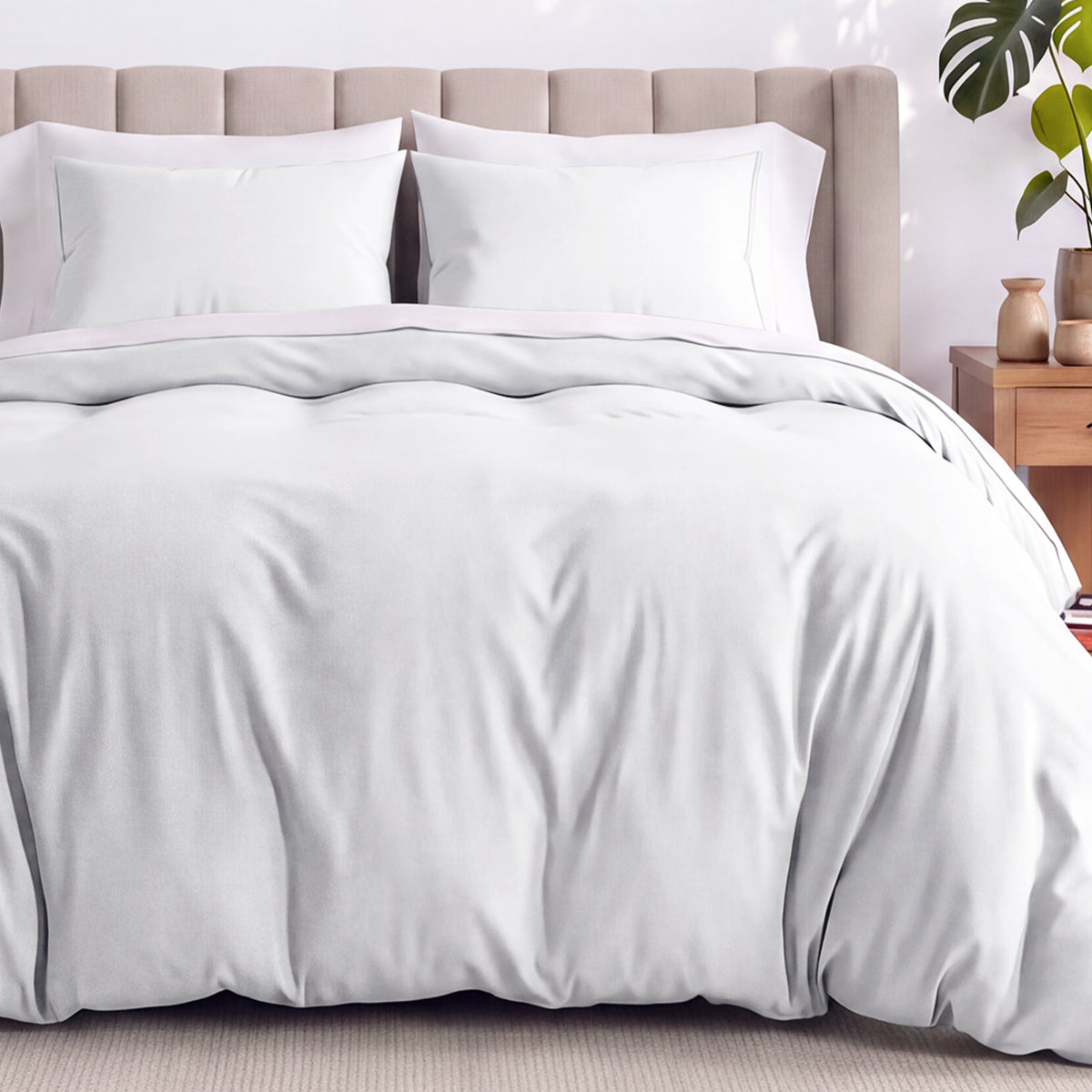 Neatly made bed with organic jersey bedding and pillow shams in a bedroom setting.