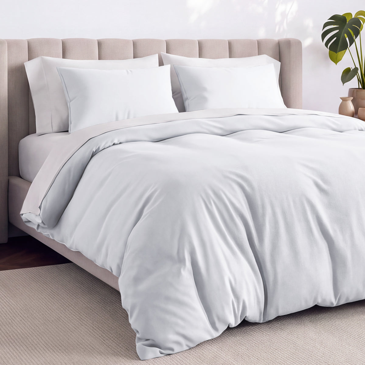 Bed with jersey duvet set against a beige headboard.
